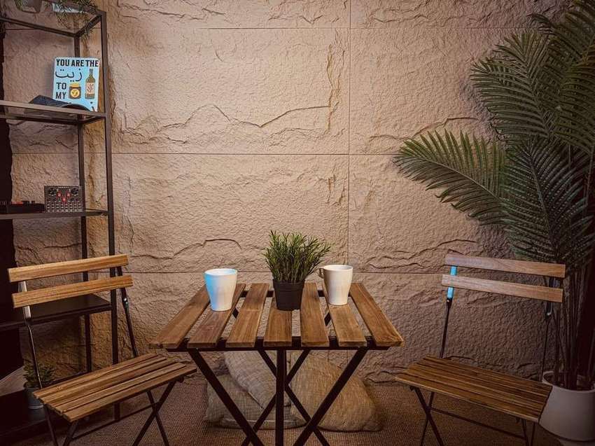 Casual stone-wall corner with bistro table and seating